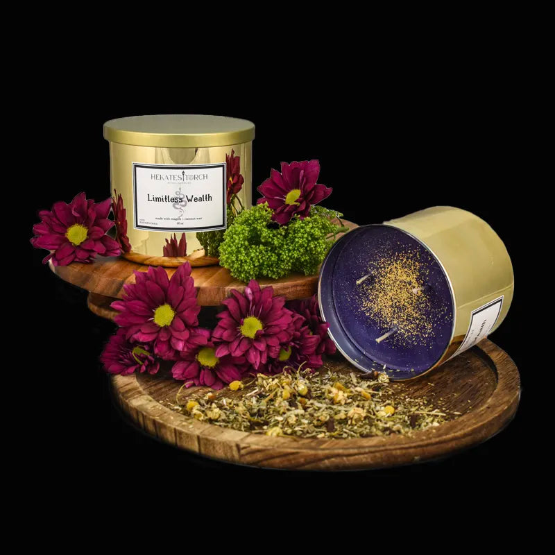 Two gold containers with purple lids on a wooden stand surrounded by purple flowers and green moss.