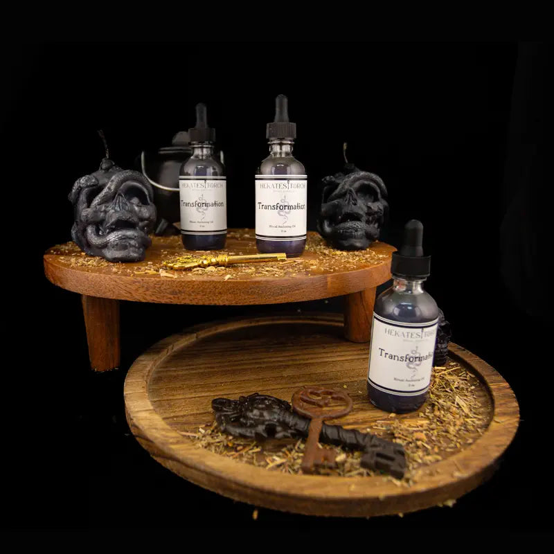 Transformational Ritual Oil Bottles on wooden stands and black skull candles